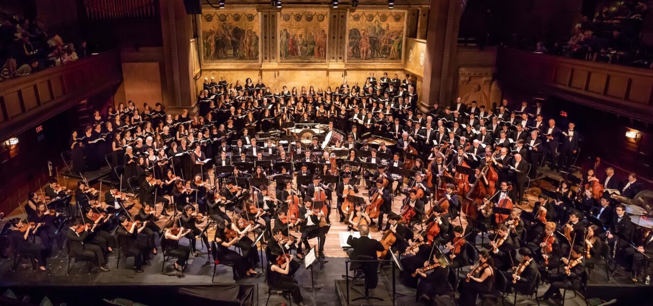photo of Princeton University Orchestra and Glee performing on stage together.