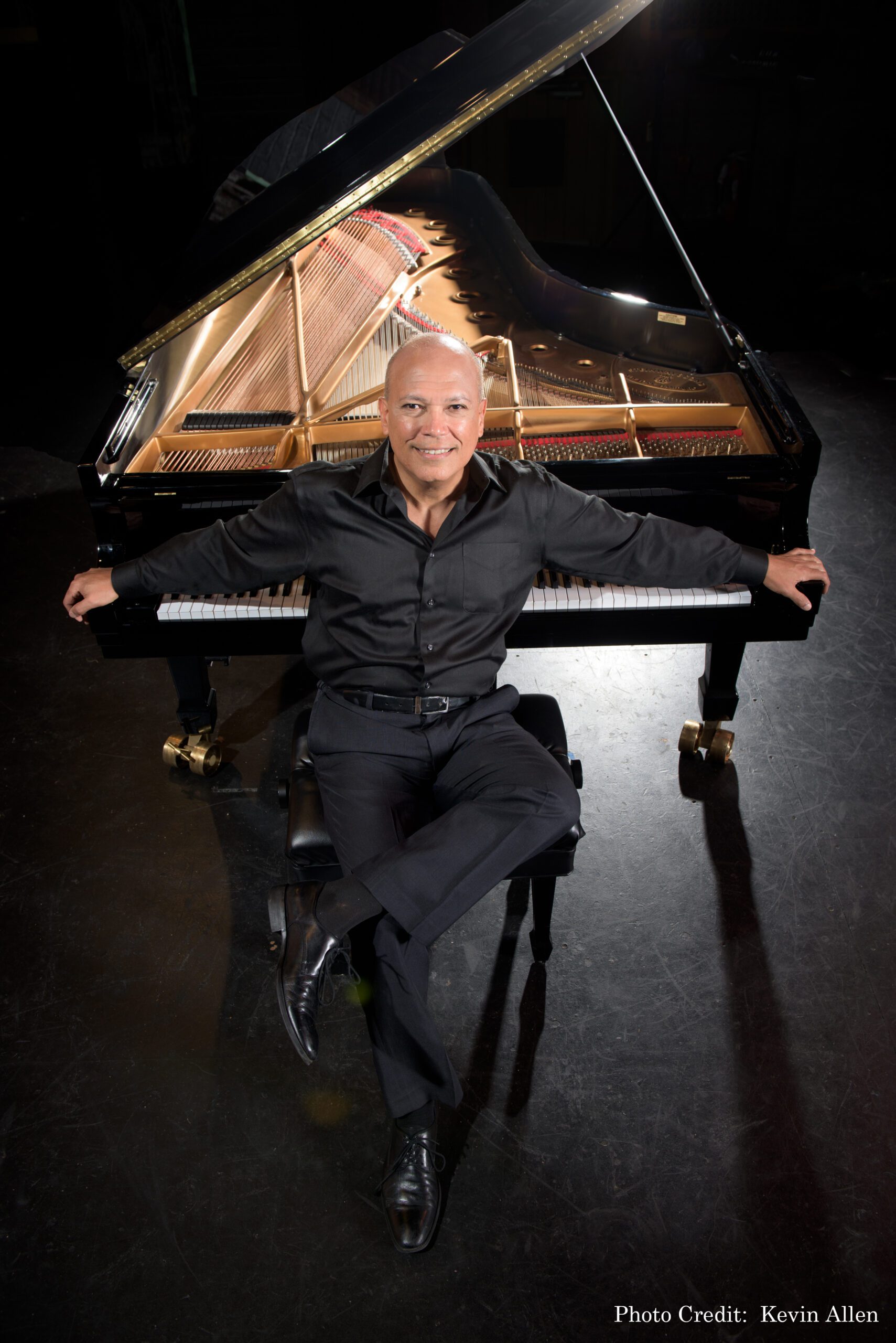 photo of Jose Ramos Santana in front of his piano
