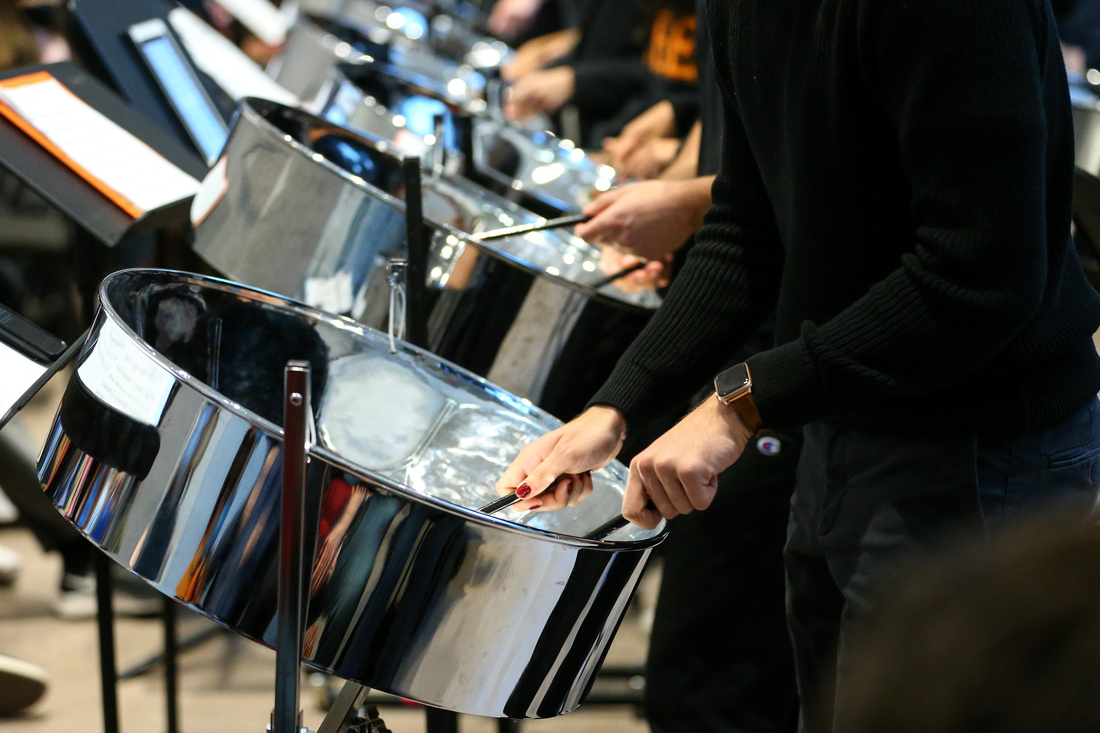 Photo of Princeton students playing steel pan drums, with a closeup on the drums