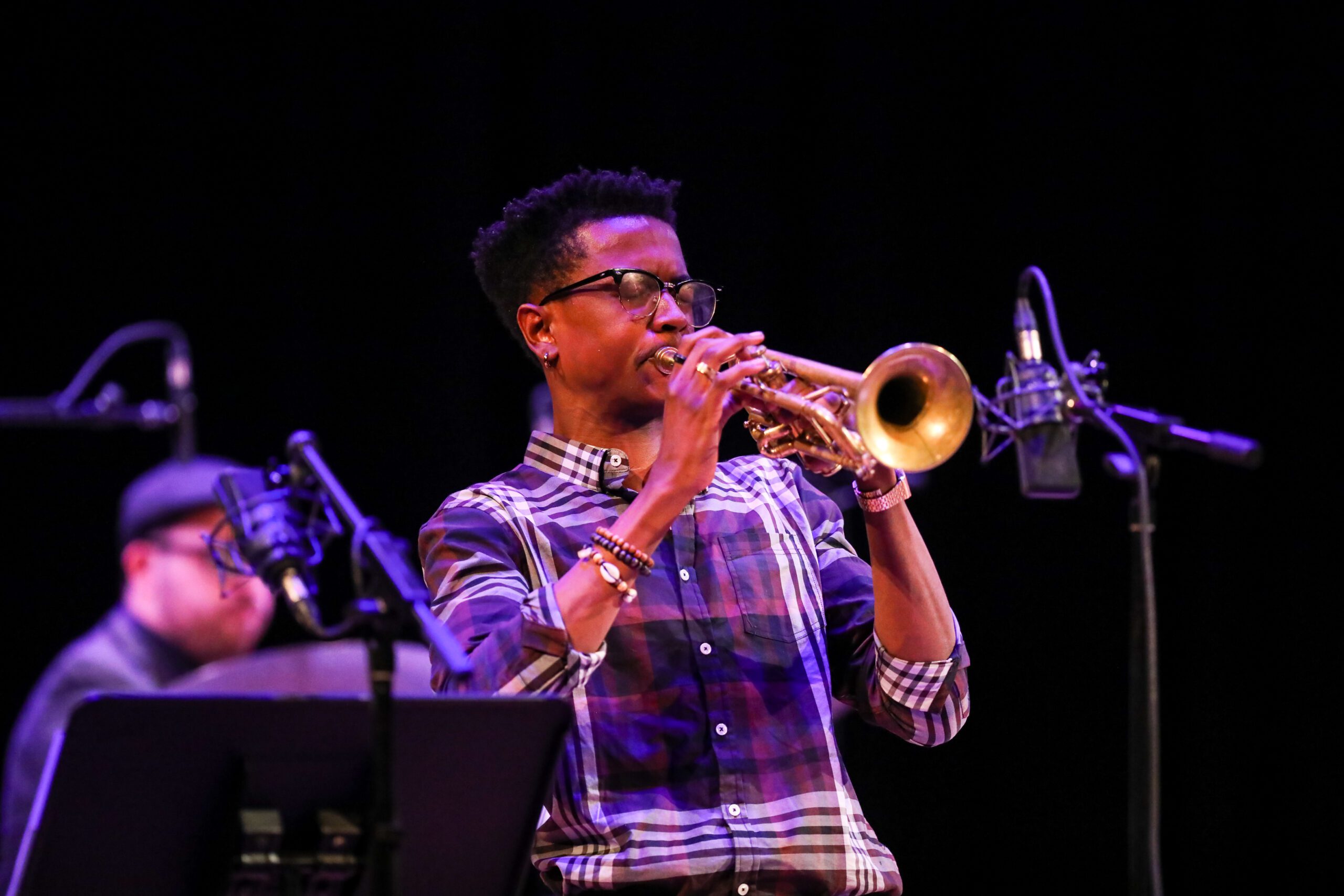 Photo of a man playing the trumpet on stage