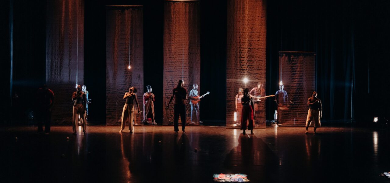 Group of people dancing in a dark room with spotlights