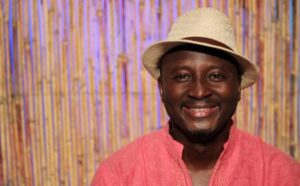 A person wearing a hat smiling